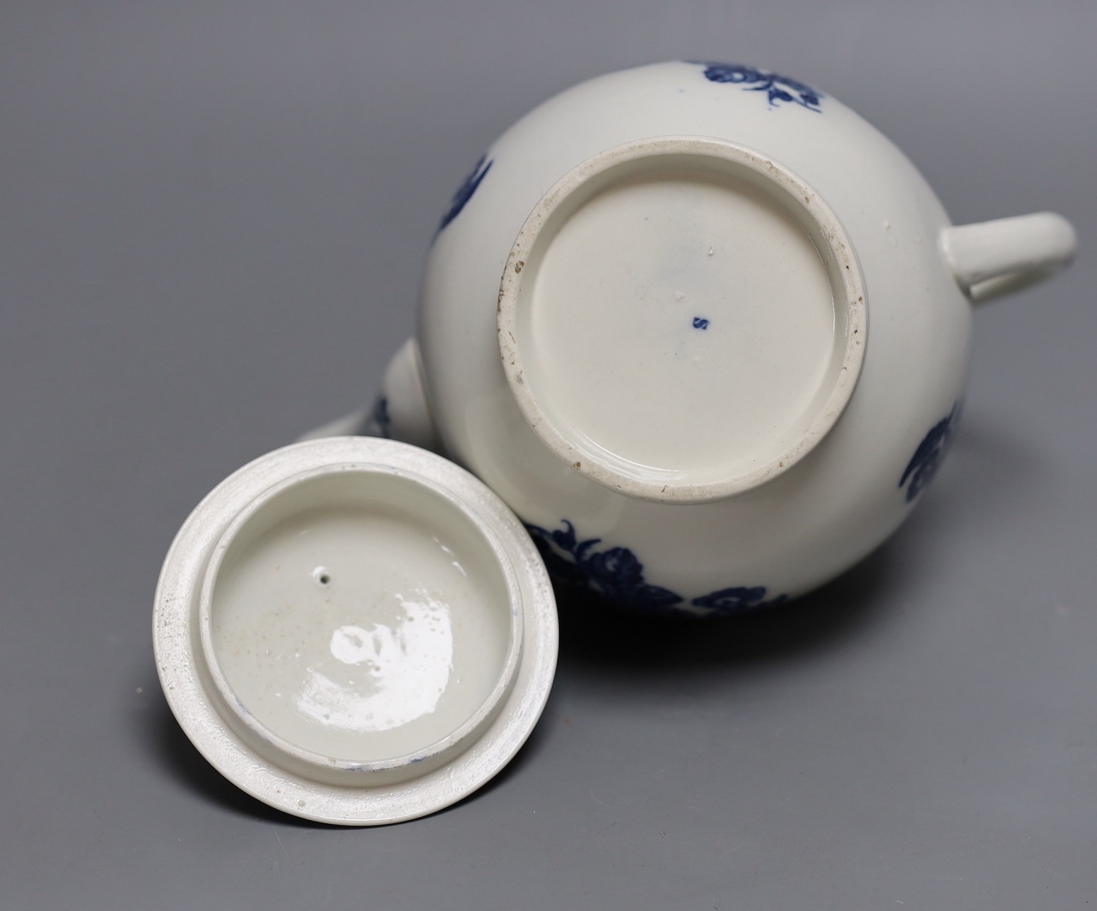 A Caughley teapot and cover printed in underglaze blue with the Three Flowers pattern, S mark in blue to base, 17 cms high